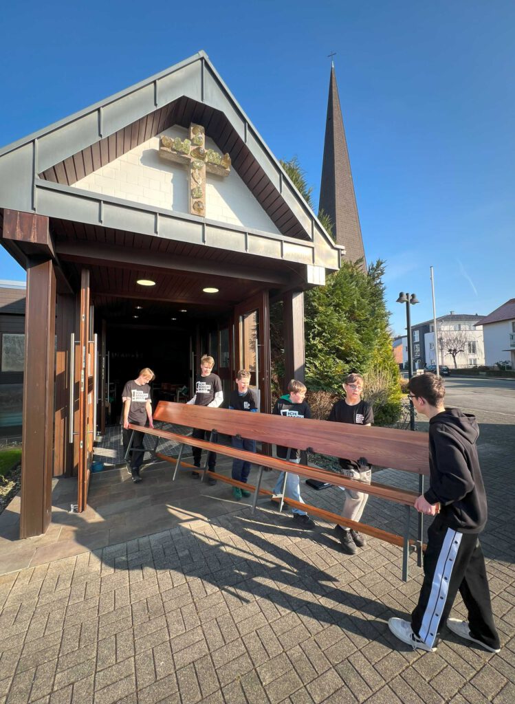 Kirchenbänke werden aus der Kirche getragen.